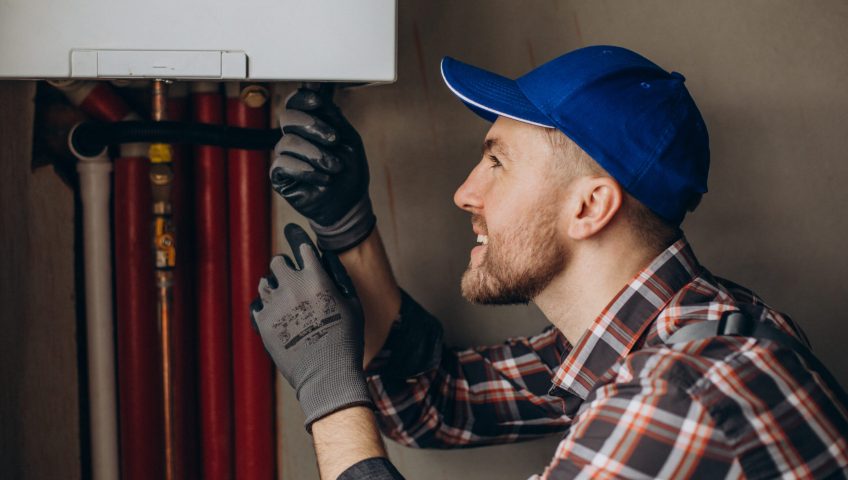 Service man adjusting house heating system